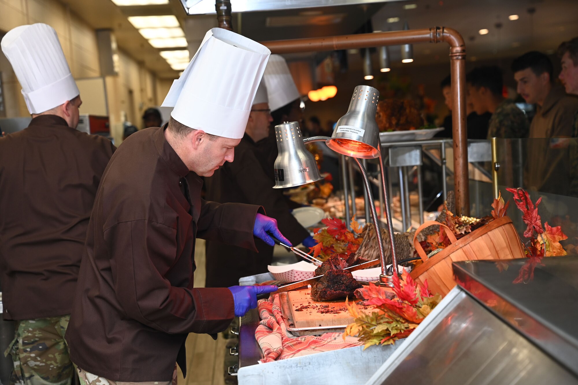 U.S. Air Force Col. Christopher Corbett, 17th Training Wing deputy commander, carves roast beef during Thanksgiving lunch at the Western Winds Dining Facility, Goodfellow Air Force Base, Texas, Nov. 23, 2023. Corbett and other leaders across the base volunteered to serve 17th TRW permanent party members and students. (U.S. Air Force photo by Airman 1st Class Evelyn D’Errico)