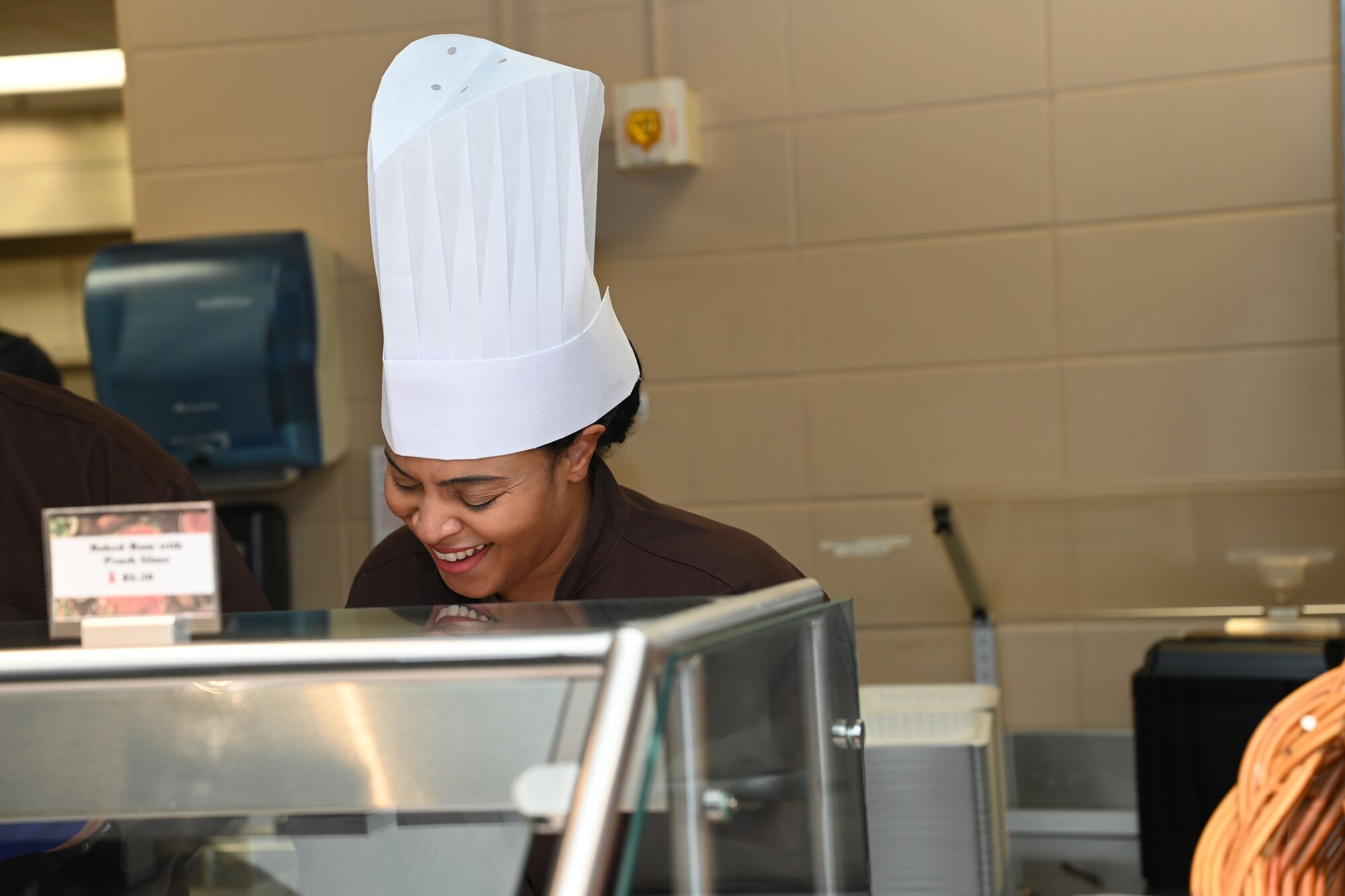 U.S. Air Force Chief Master Sgt. Khamillia Washington, 17th Training Wing command chief, serves meat to students during Thanksgiving lunch at the Western Winds Dining Facility, Goodfellow Air Force Base, Texas, Nov. 23, 2023. Washington served service members and interacted with them during the event. (U.S. Air Force photo by Airman 1st Class Evelyn D’Errico)