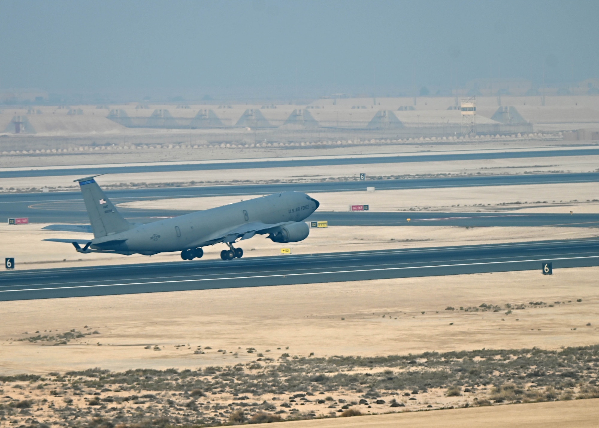 Aircraft takes off from flight line.