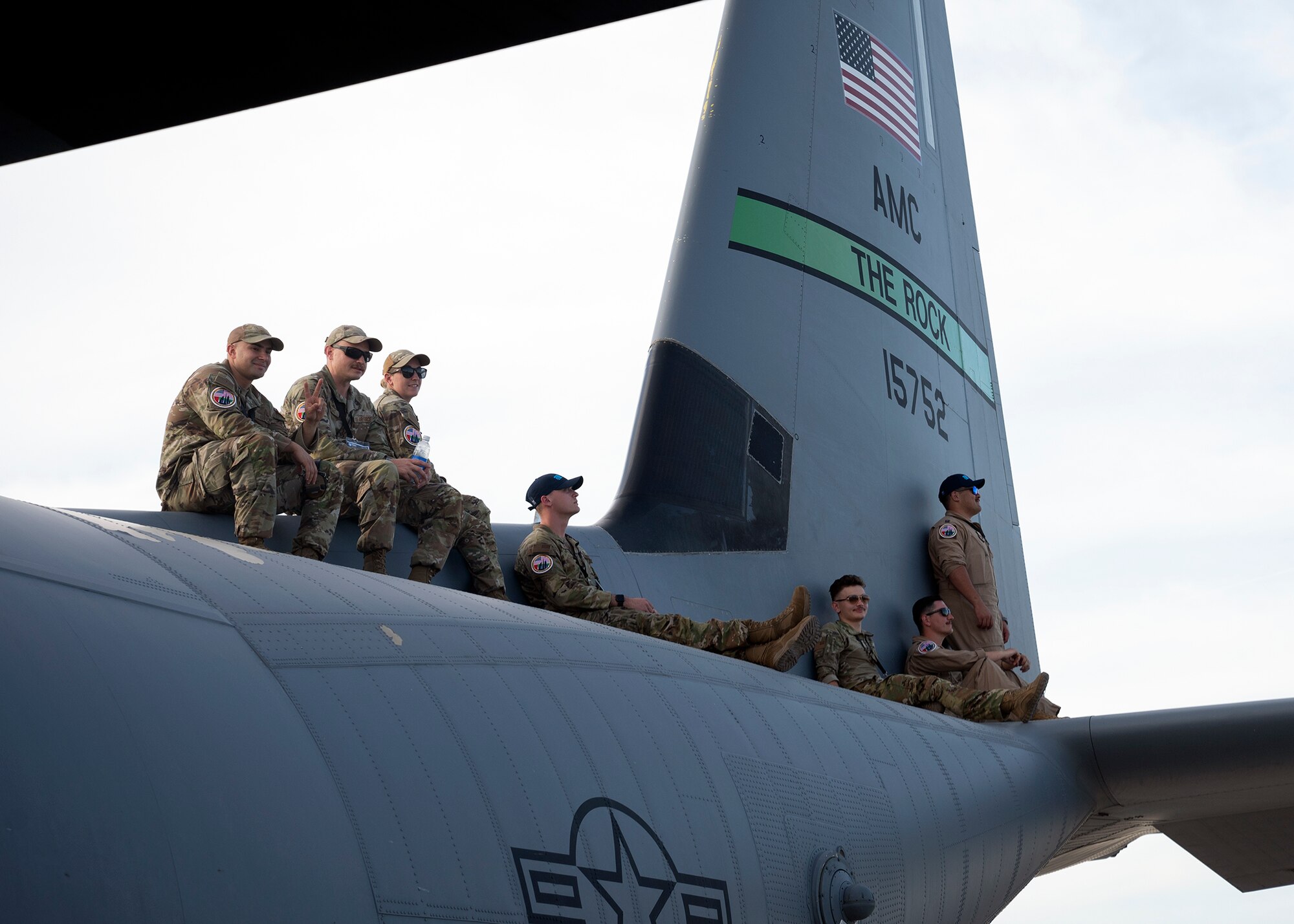 Airmen watch aircraft perform.