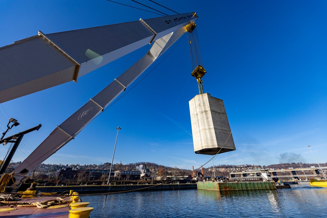 Contractors working for the U.S. Army Corps of Engineers Pittsburgh District install a 23-foot-tall concrete shaft enclosure weighing approximately 120,000 pounds as part of the guard wall at the Monongahela River Locks and Dam 4 in Charleroi, Pennsylvania, Nov. 16, 2023.
