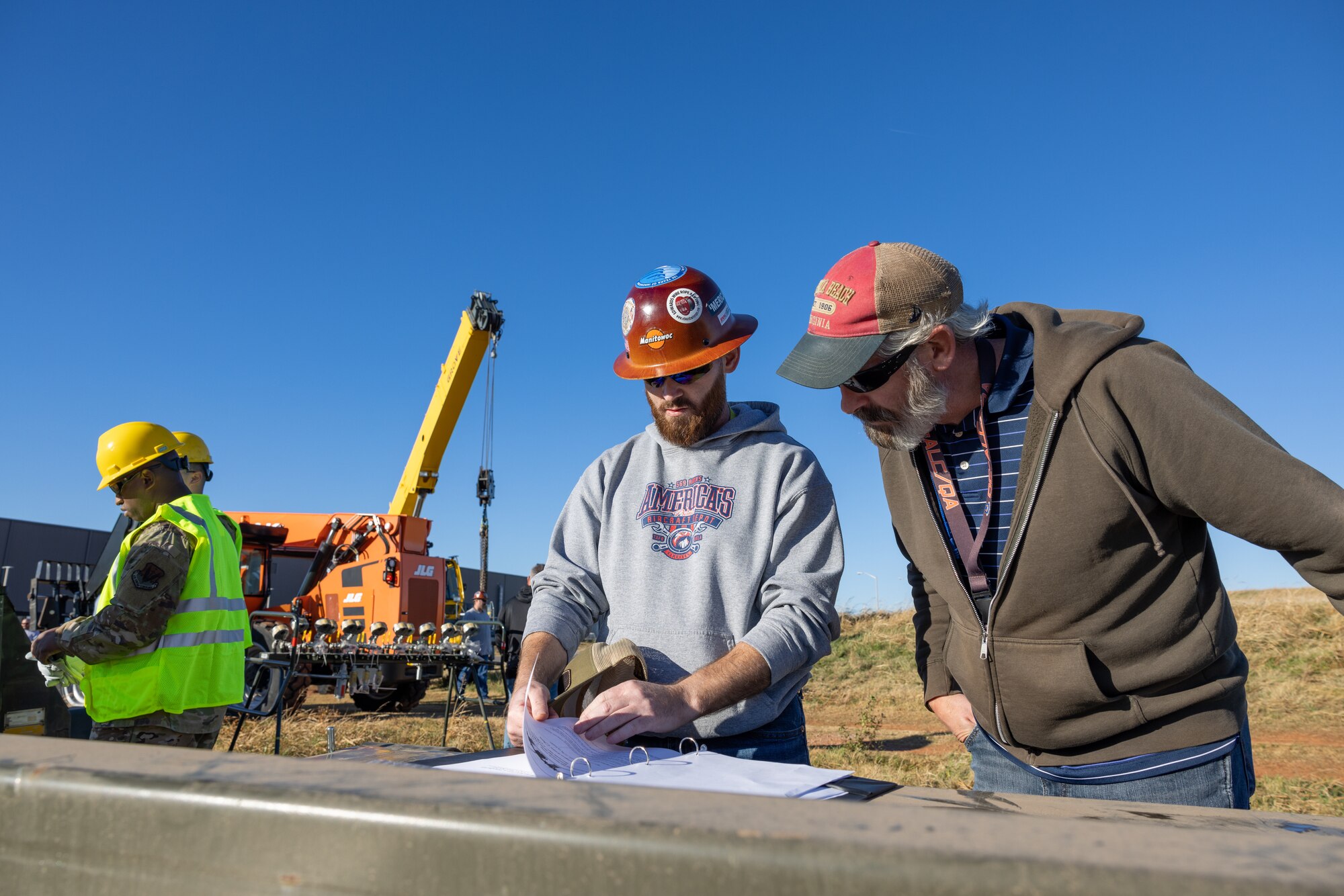 Members from the 552nd Maintenance Group, the 507th Maintenance Group and the 569th Aircraft Maintenance Squadron review plans.