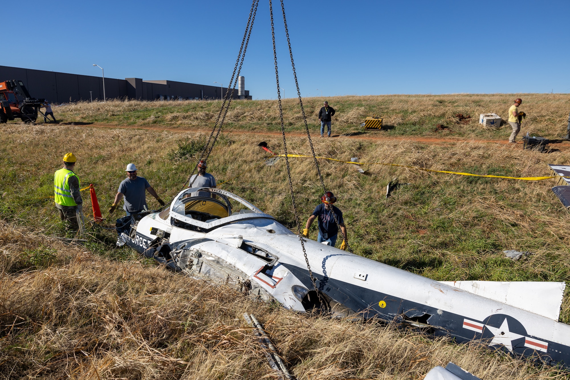 Members from the 552nd Maintenance Group, the 507th Maintenance Group and the 569th Aircraft Maintenance Squadron secure chains to the T-37 Tweet trainer aircraft.
