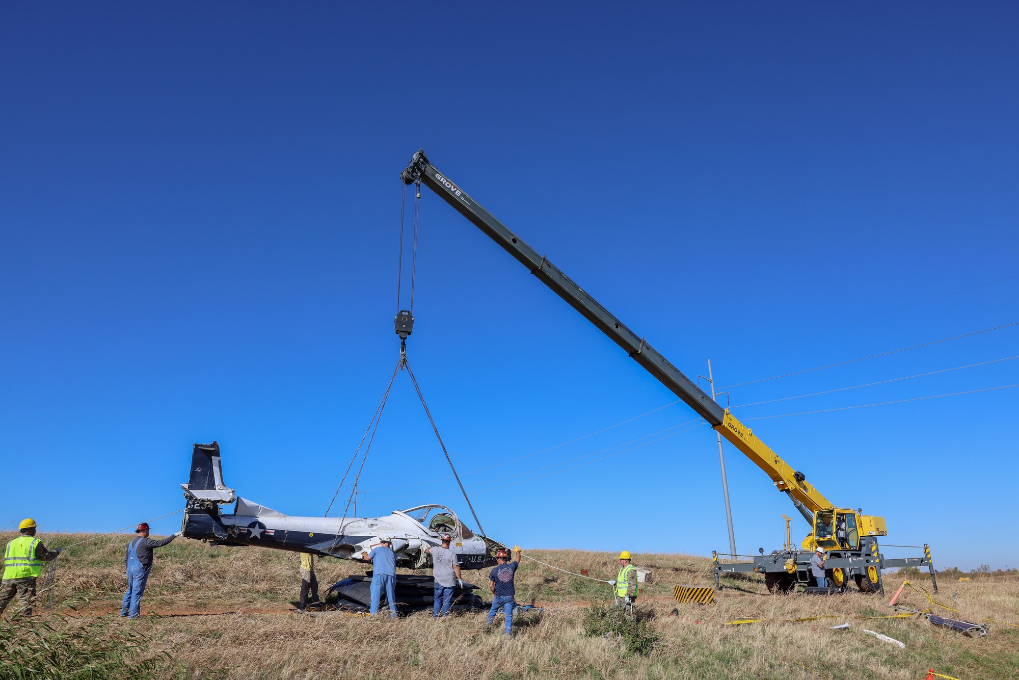 Members from the 552nd Maintenance Group, the 507th Maintenance Group and the 569th Aircraft Maintenance Squadron lift T-37 Tweet trainer aircraft.