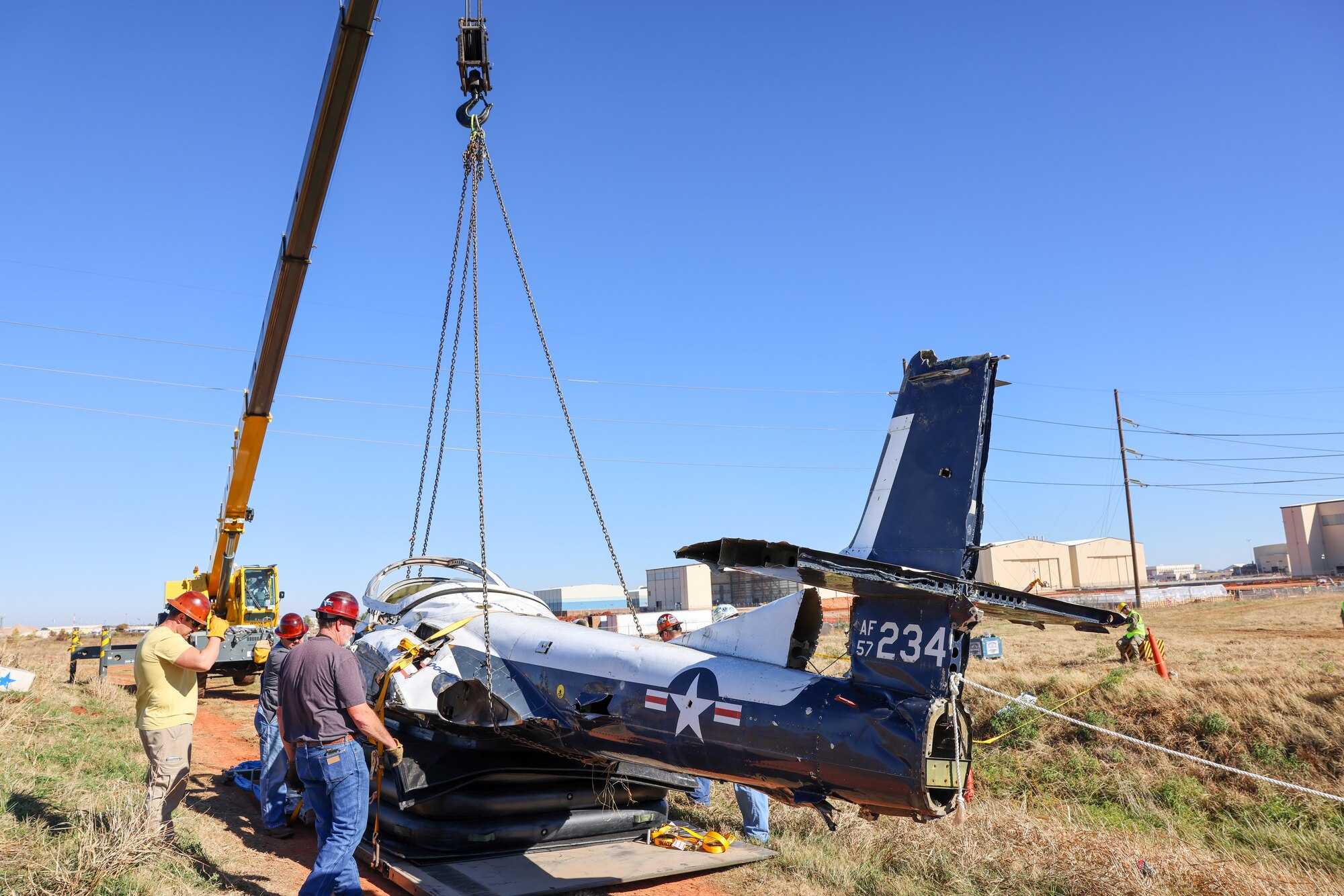 Members from the 552nd Maintenance Group, the 507th Maintenance Group and the 569th Aircraft Maintenance Squadron secure the T-37 Tweet trainer aircraft.