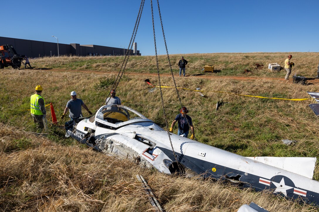 Members from the 552nd Maintenance Group, the 507th Maintenance Group and the 569th Aircraft Maintenance Squadron secure chains to the T-37 Tweet trainer aircraft.