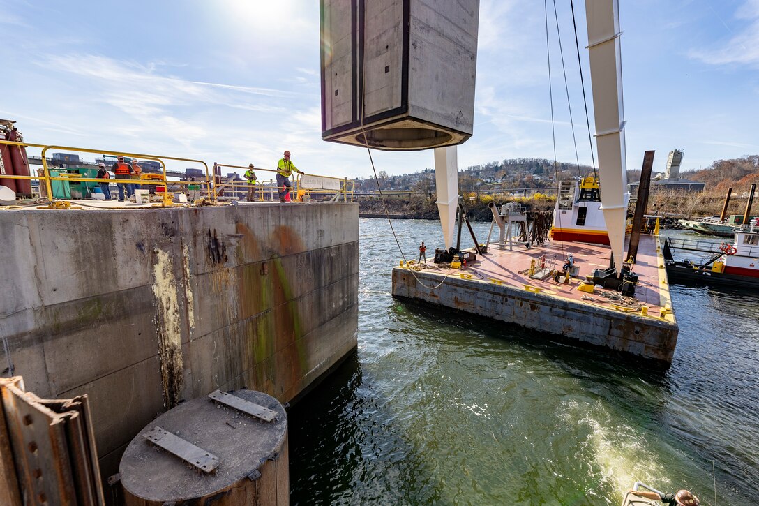 Contractors working for the U.S. Army Corps of Engineers Pittsburgh District install a 23-foot-tall concrete shaft enclosure weighing approximately 120,000 pounds as part of the guard wall at the Monongahela River Locks and Dam 4 in Charleroi, Pennsylvania, Nov. 16, 2023.