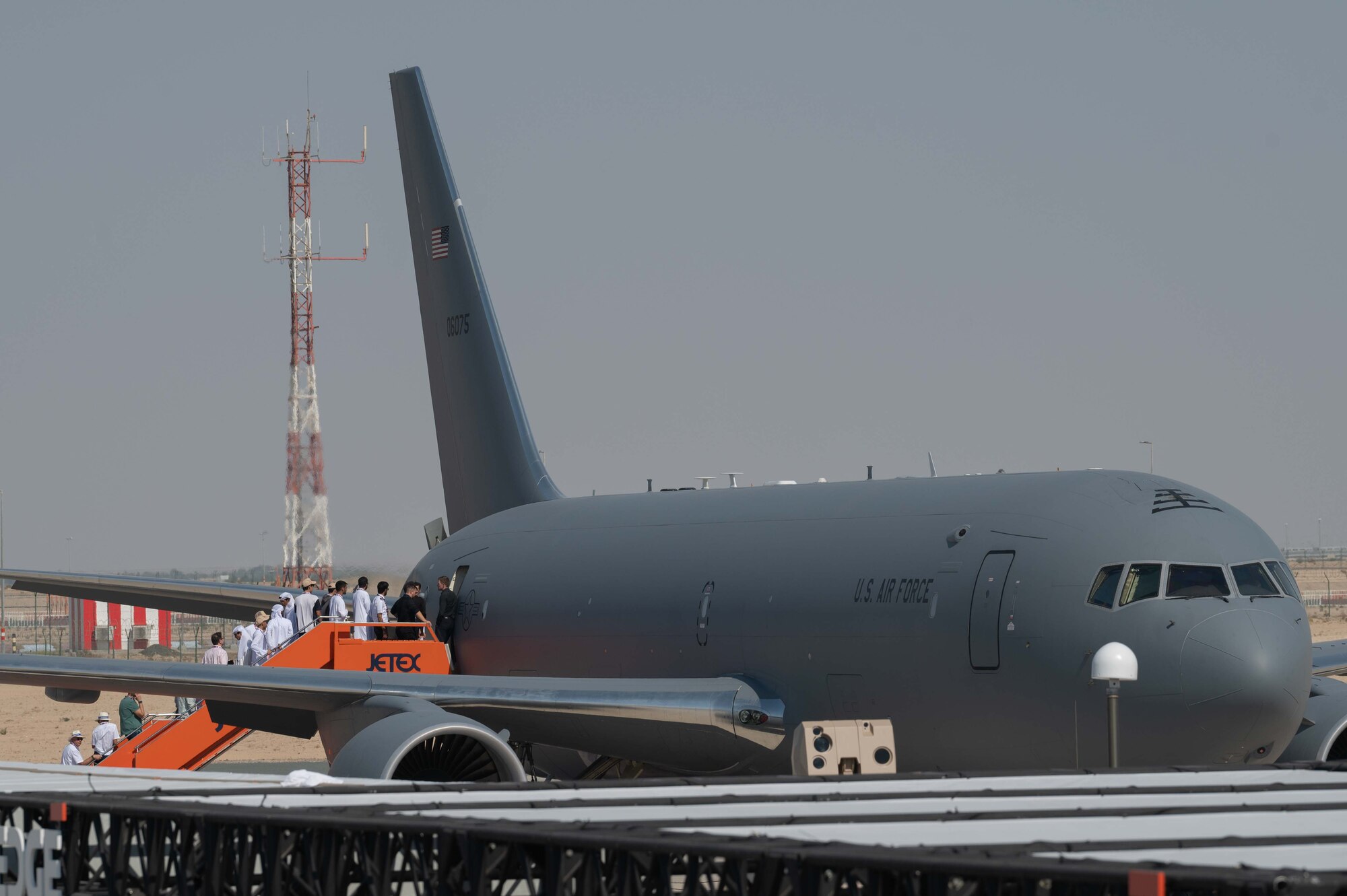 People enter an aircraft on the flightline.