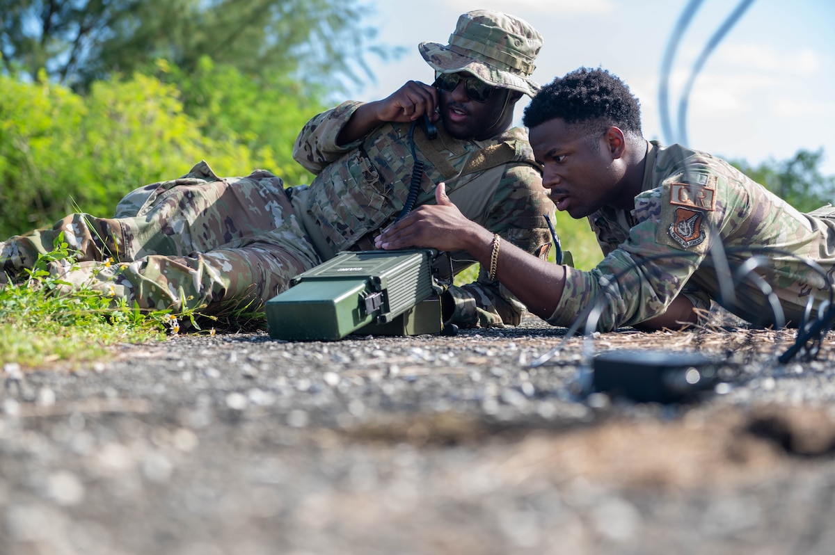 U.S. Air Force Staff Sgt. Joshua Fobbs, 644th Combat Communications Squadron RF Operations Supervisor, and U.S. Air Force Airman 1st Class Jaylen Short, 644th Combat Communication Squadron RF Operations Technician, prepares the radio in preparation to communicate with members from the 644th CBCS on Andersen Air Force Base, Guam, at Tinian, Nov. 14, 2023.