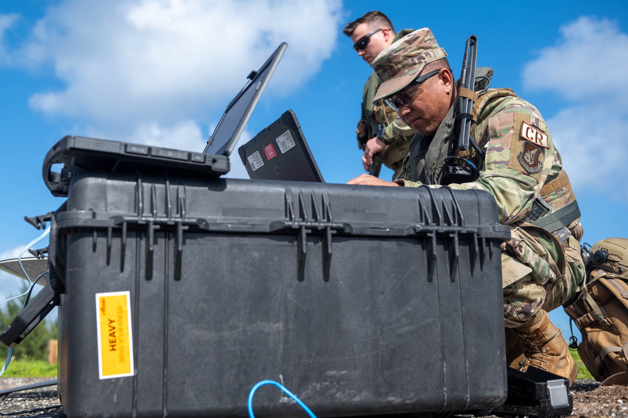 U.S. Air Force Tech Sgt. Joffrey Matute, 644th Combat Communication Squadron client systems operations supervisor, helps set up a communications system at Tinian, Nov. 14, 2023.
