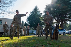 U.S. Air Force Staff Sgt. Micheal Dacoron and Airman 1st Class Samuel Mcpheron, 35th Security Forces Squadron military working dog (MWD) handlers, perform a MWD Demonstration for Aomori Prefecture Police cadets at Misawa Air Base, Japan.
