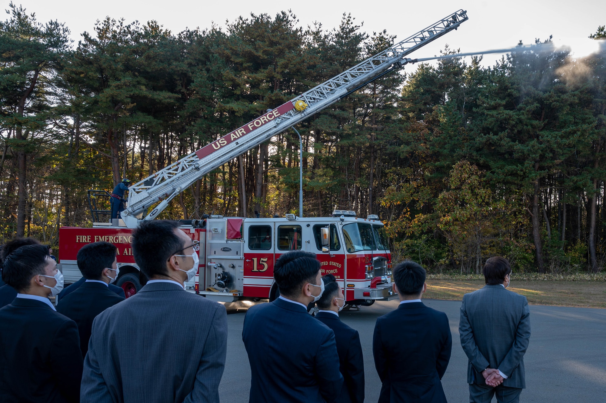 Aomori Prefecture Police cadets watch as a fire engine displays its ability to spray water remotely at Misawa Air Base, Japan.