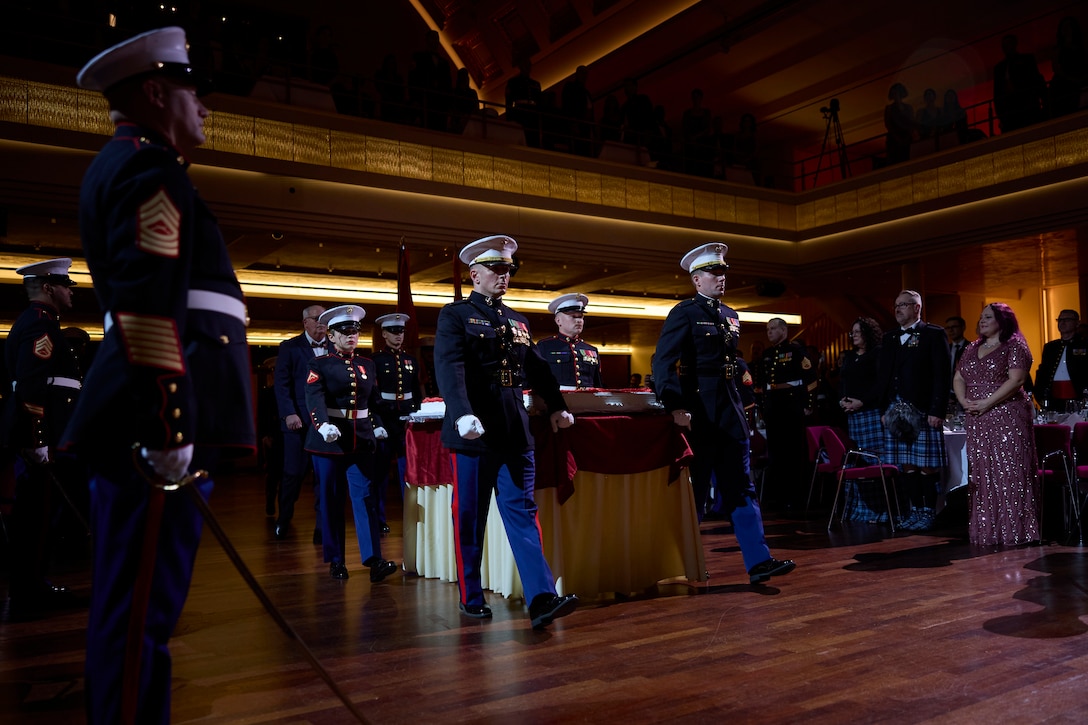 U.S. Marines with U.S. Marine Corps Forces Europe and Africa march out the birthday cake during the 248th Marine Corps ball ceremony hosted at Kurhaus, Baden-Baden, Germany, Nov. 18, 2023. Every year, Marines across the world get together to celebrate and honor the history and legacy of the United States Marine Corps. (U.S. Marine Corps photo by Lance Cpl. Mary Linniman)