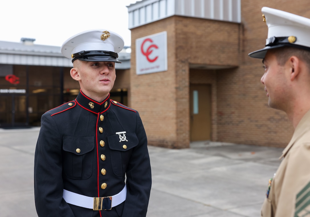 U.S. Marine Corps Pvt. Dakota Certain, left, a Marine with the command recruiting program at Recruiting Substation (RSS) Murfreesboro, Recruiting Station Nashville, speaks to Staff Sgt. Nathan Haaland, right, a recruiter with RSS Murfreesboro, at Coffee County Central High School, Manchester, Tennessee, Oct. 19, 2023. This program offers new Marines the opportunity to return to their recruiting station in support of recruiting efforts. (U.S. Marine Corps photo by Cpl. Bernadette Pacheco)