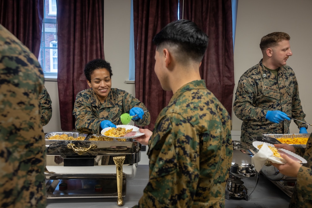 U.S. Marine Corps Gunnery Sgt. Karen Pajaro-Torres, separations staff non-commissioned officer in charge with Installation Personnel Administration Center, celebrates the holiday by helping serve food to his junior Marines at the Security Battalion Thanksgiving Barracks Feast on Marine Corps Base Quantico, Virginia, November 21, 2023. Security Battalion’s annual Turkey Feast is a way for Non-Commissioned Officers and Officers of Security Battalion to give back and serve junior Marines as a part of the Thanksgiving holiday. (U.S. Marine Corps photo by Lance Cpl. Jeffery Stevens)