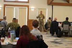 USMEPCOM Commander Col. Megan Stallings briefs attendees of the FY24 Senior Leader Offsite on the command's newest strategic plan. The strategic plan lays out the collective vision for USMEPCOM, guiding its projects and goals into 2033.