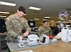 Sgt. Jason Paglia and Staff Sgt. Nora Martinez perform maintenance on patient monitors at the U.S. Army Medical Materiel Agency's Medical Maintenance Operations Division at Hill Air Force Base, Utah, Nov. 14, 2023.