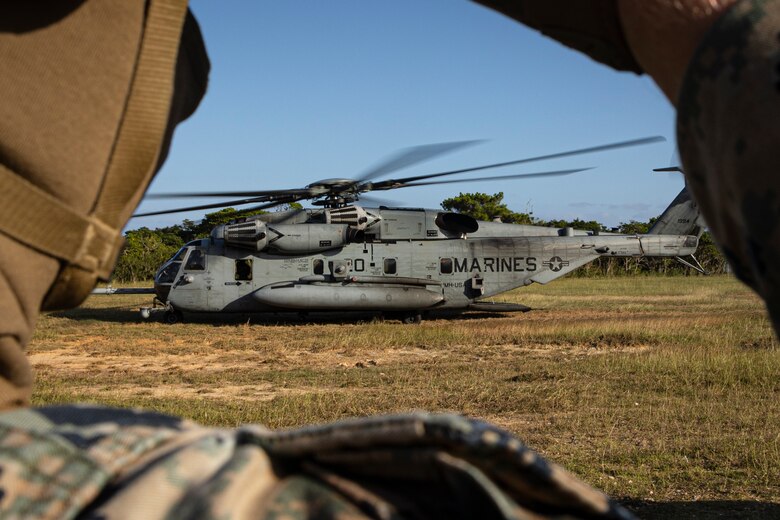 U.S. Marine Corps Cpl. Jacob Wyman with Combat Logistics Battalion 31, 31st Marine Expeditionary Unit, watches a CH-53 Super Stallion Land during a helicopter support team training on Camp Hansen, Okinawa, Japan, Nov. 7, 2023. The HST exercise was conducted to refine key skills for pilots and landing support Marines in sling loading operations. The 31st MEU, the Marine Corps’ only continuously forward-deployed MEU, provides a flexible and lethal force in ready to perform a wide range of military operations as the premiere crisis response force in the Indo-Pacific region. (U.S. Marine Corps photo by Cpl. Juan K. Maldonado)