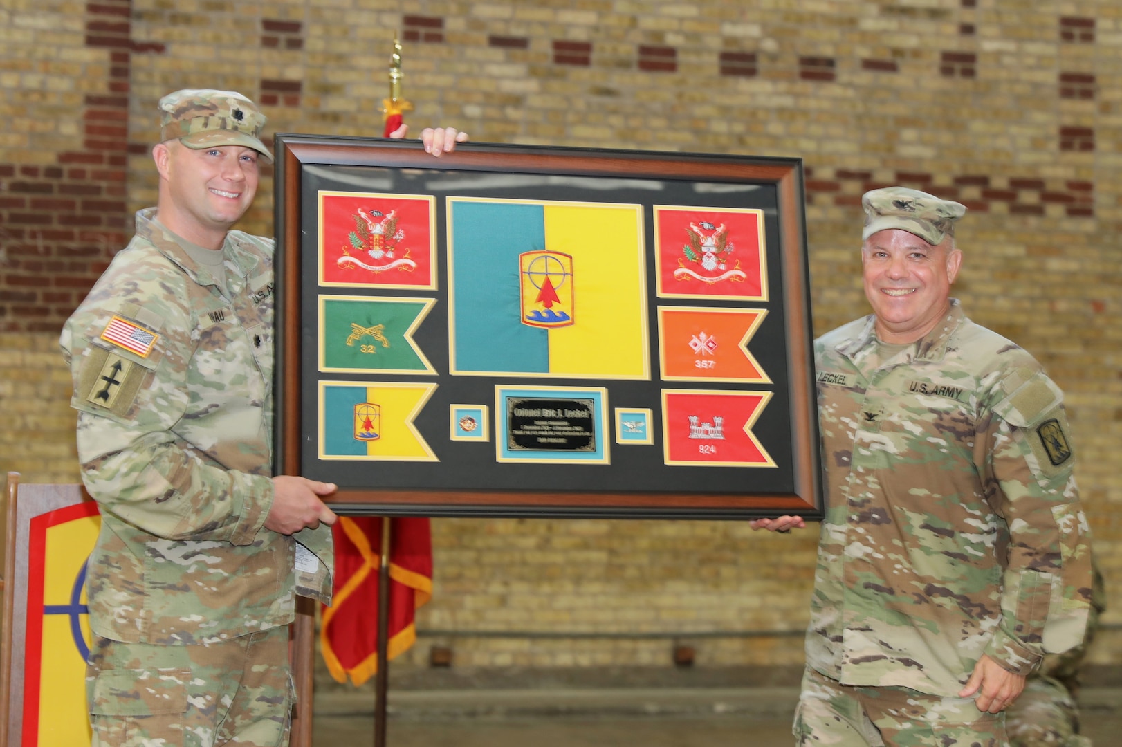 Col. Eric Leckel, outgoing commander of the 157th Maneuver Enhancement Brigade, receives a gift from the unit during a formal change of command ceremony Nov. 4 at the Richards Street Armory in Milwaukee. Col. Paul Gapinski assumed command of the brigade. Wisconsin National Guard photo by Sgt. 1st Class Katie Theusch