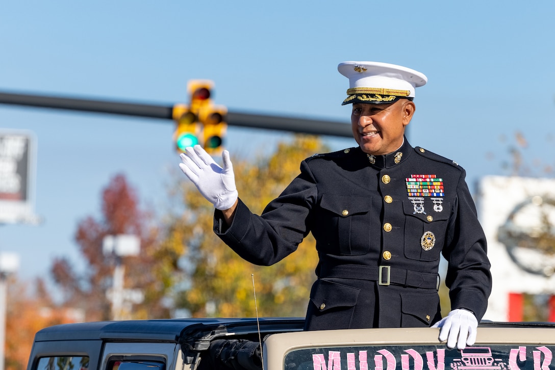 U.S. Marine Corps Col. Adolfo Garcia Jr., commander, Marine Corps Installations East-Marine Corps Base Camp Lejeune, waves at parade attendees during the 67th Annual Onslow County Holiday Parade in Jacksonville, North Carolina, Nov. 18, 2023. The parade has been a Jacksonville tradition for 67 years, showcasing local businesses and organizations while also highlighting community and military leaders. (U.S. Marine Corps photo by LCpl. Alyssa J. Deputee)