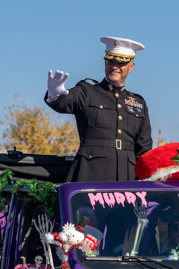 U.S. Marine Corps Col. Garth W. Burnett, commanding officer, Marine Corps Air Station New River, waves at the crowd during the 67th Annual Onslow County Holiday Parade in Jacksonville, North Carolina, Nov. 18, 2023. The parade has been a Jacksonville tradition for 67 years, showcasing local businesses and organizations while also highlighting community and military leaders. (U.S. Marine Corps photo by LCpl. Alyssa J. Deputee)