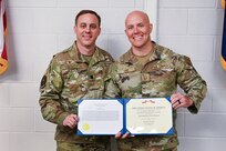 U.S. Air Force Master Sgt. Christopher Vine, a radar, airfield, and weather systems technician with the 245th Air Traffic Control Squadron at McEntire Joint National Guard Base, South Carolina Air National Guard, is presented the Bronze Star Medal from Lt. Col. Zachary Counts, the 245th ATCS commander, Oct. 15, 2023. Vine received the award for his achievements while deployed to Iraq in 2022.