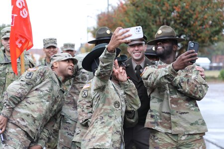 Cyber Center of Excellence and Fort Eisenhower Commanding General Maj. Gen. Paul Stanton poses for selfies with soldiers from the 15th Signal Brigade.