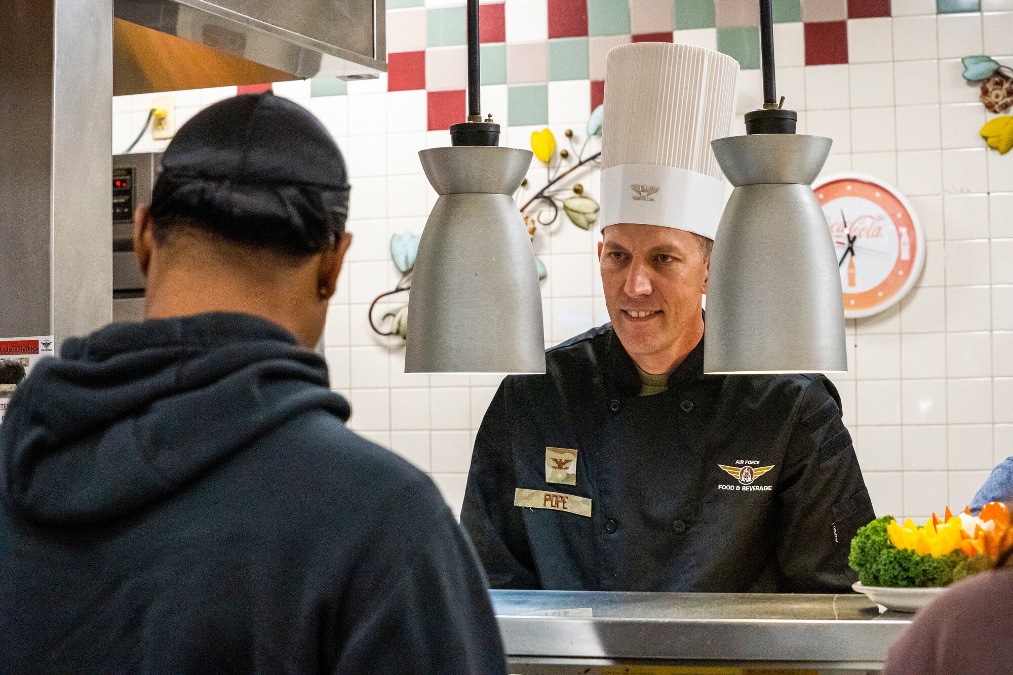 U.S. Air Force Col. Billy Pope Jr., 81st Training Wing commander, serves a Thanksgiving meal to an Airman at Keesler Air Force Base, Mississippi, Nov. 23, 2023.