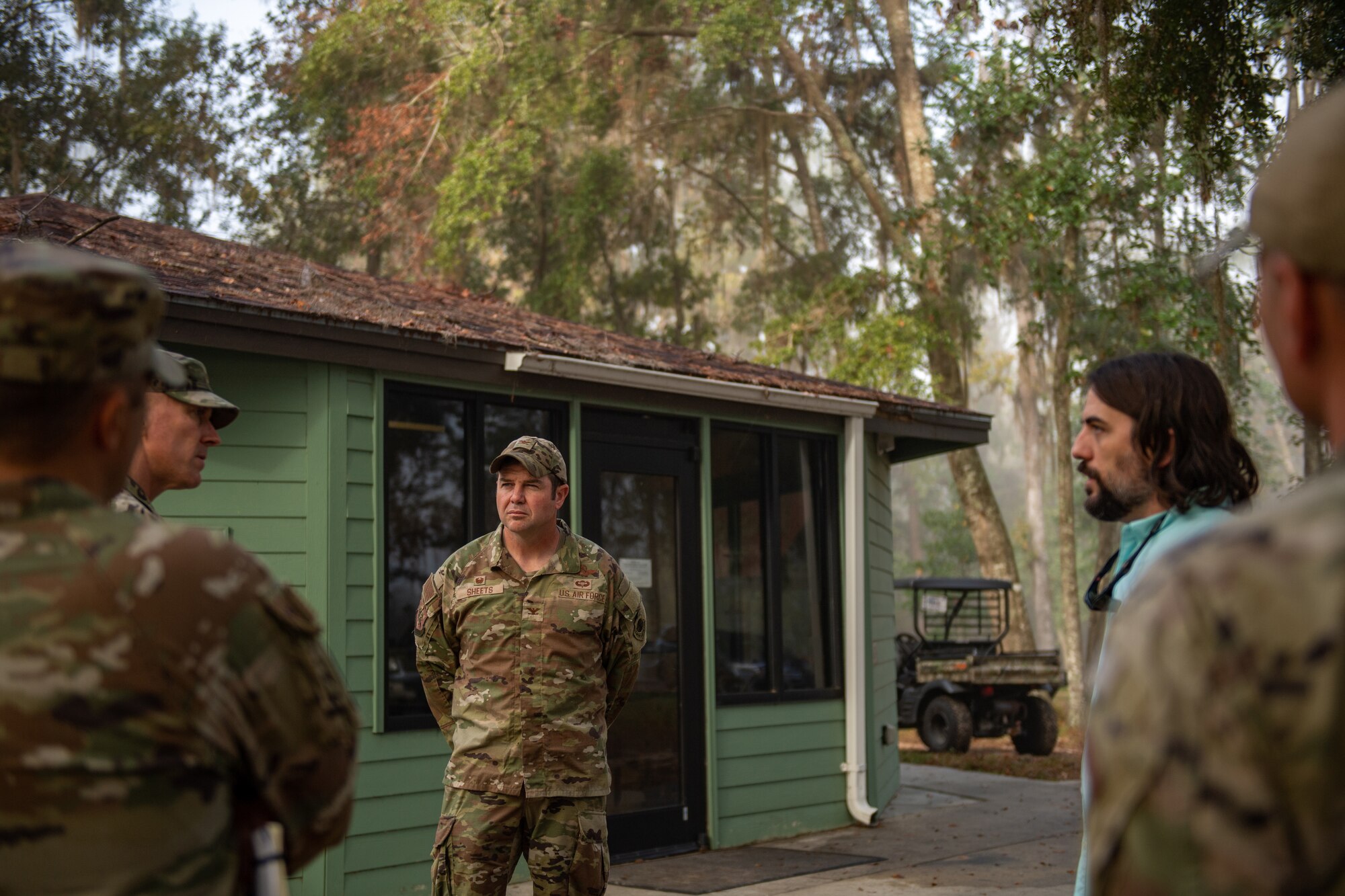 U.S. Air Force Col. Paul Sheets, 23rd Wing Commander, middle, discusses the restoration process at Grassy Pond in Lake Park, Georgia, Oct. 30, 2023. The current plan is to re-open parts of the site in phases starting in late spring of 2024. (U.S. Air Force photo by Senior Airman Courtney Sebastianelli)