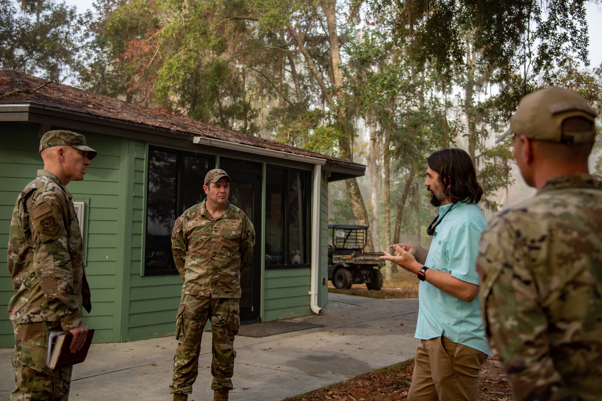U.S. Air Force Col. Paul Sheets, 23rd Wing commander, middle, and Col. Michael Gallagher, 23rd Mission Support Group commander, far left, discuss restoration plans with Josh Davis, supervisory recreation specialist, at Grassy Pond in Lake Park, Georgia, Oct. 30, 2023. Restoration to the facilities and amenities is a priority for both Lowndes County and Moody Air Force Base, Georgia, as cabins, structures, power lines, water pipes and trees throughout the grounds all sustained damages from Hurricane Idalia. (U.S. Air Force photo by Senior Airman Courtney Sebastianelli)