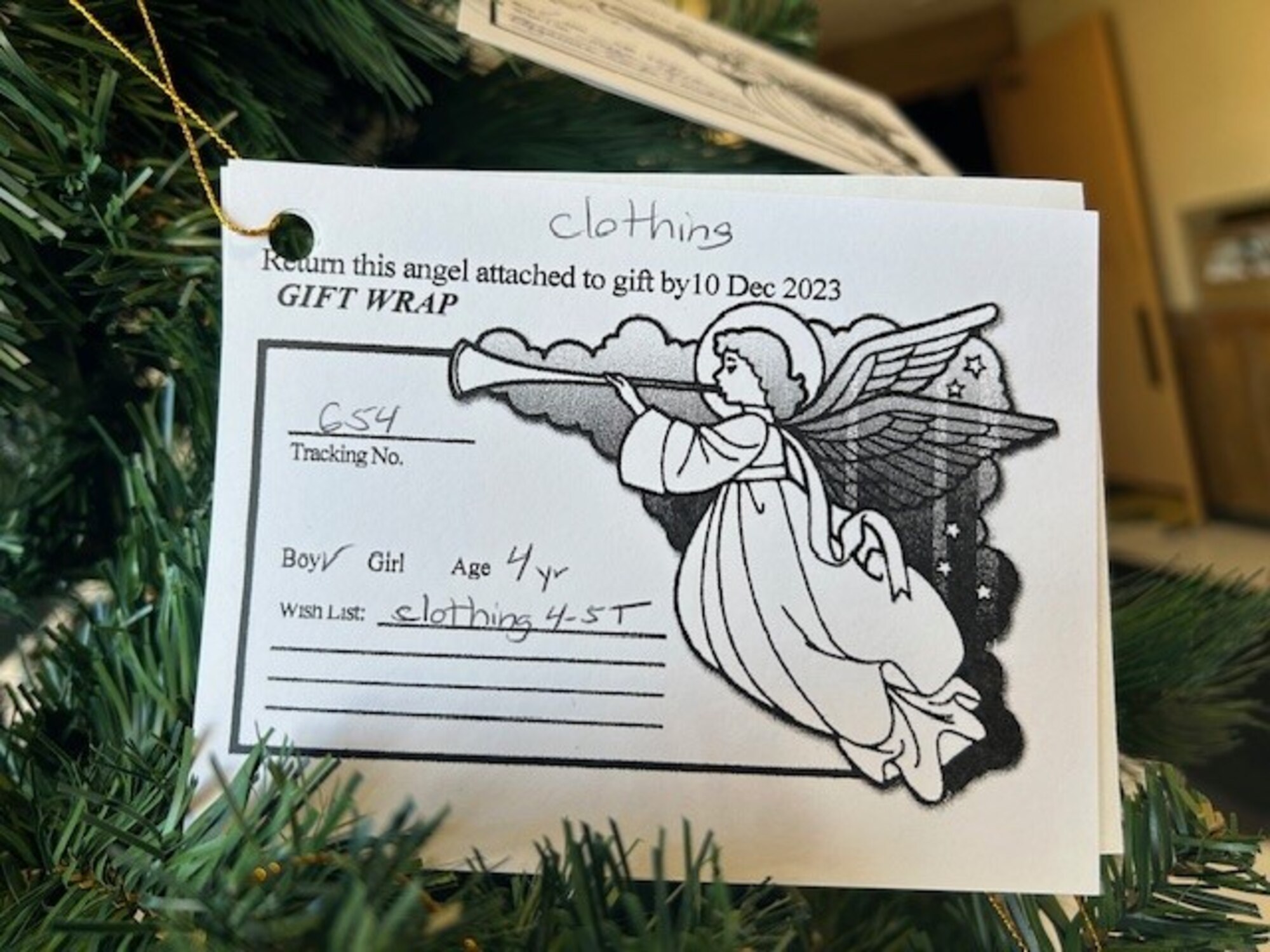 A paper card with an Angel