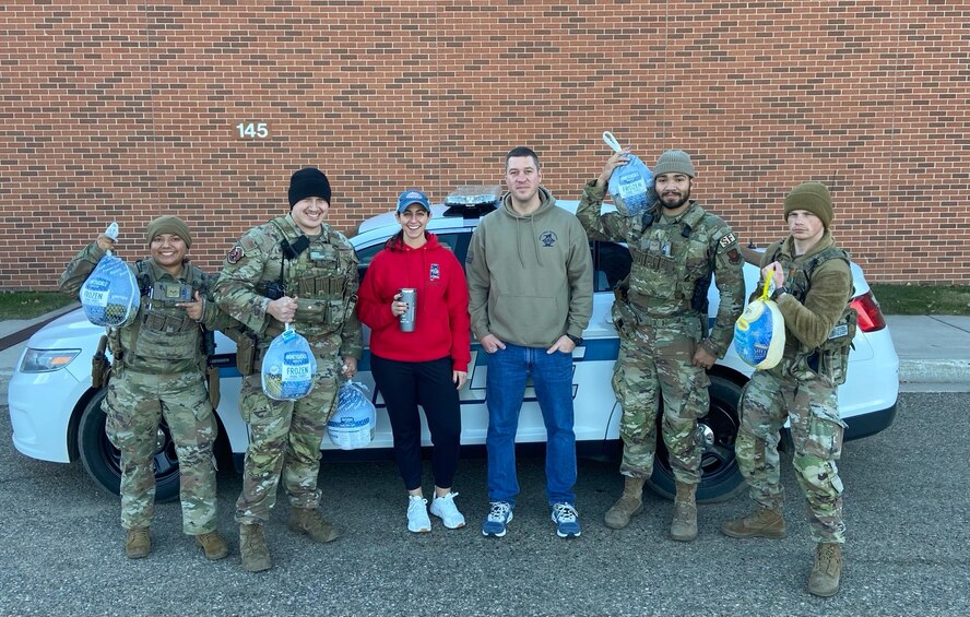 Members of Team Minot pose for a photo during the Share the Joy Program at Minot Air Force Base, North Dakota, Nov. 18, 2023. The Share the Joy Program was part of Operation Warm heart, which gave people the opportunity to donate thanksgiving meals to families stationed at Minot AFB. (Courtesy photo)