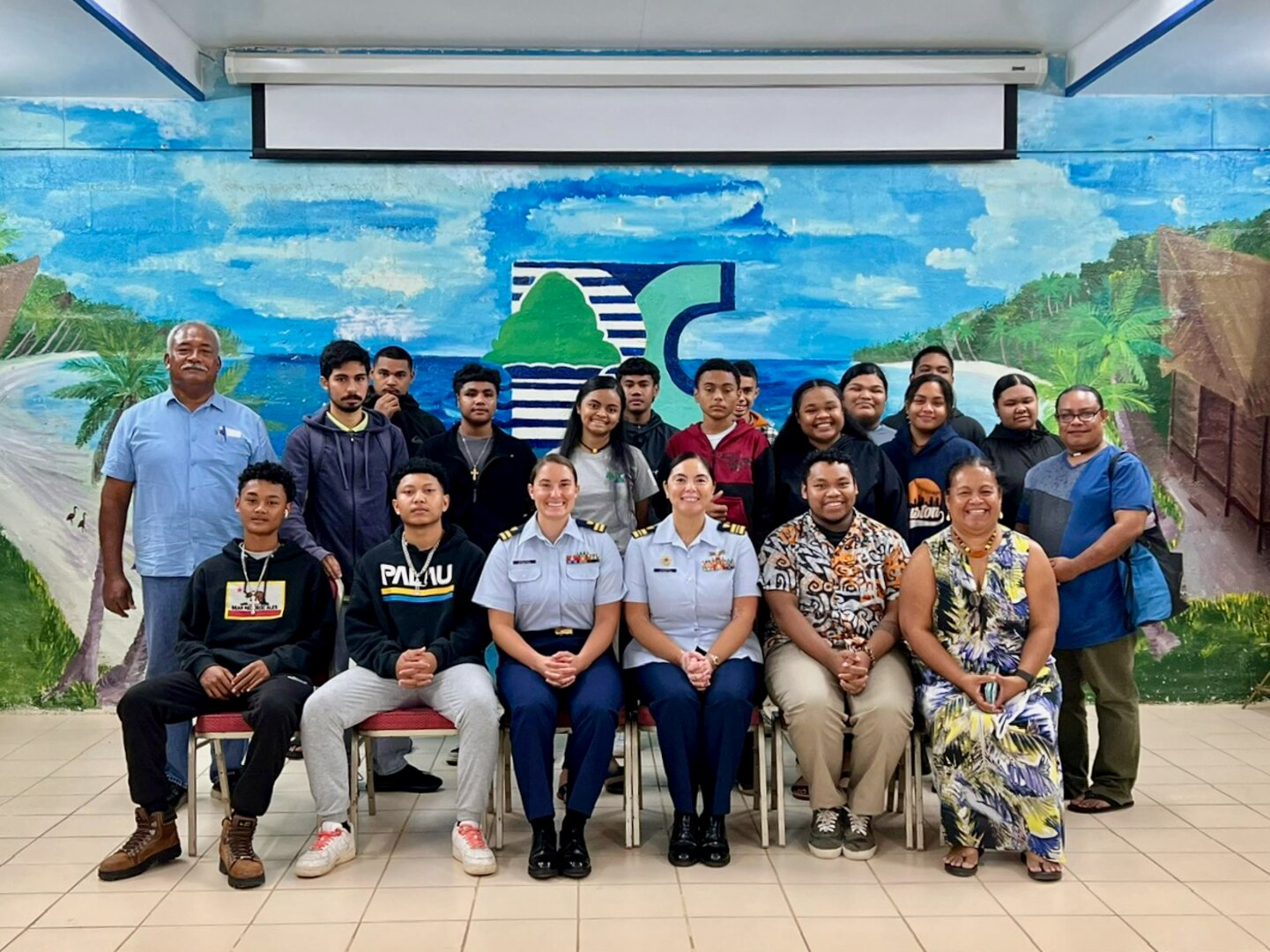 Faculty, students, and U.S. Coast Guard members take a moment for a photo at Palau Community College in Koror, Palau, in November 2023. In an enduring commitment to regional stability and cooperative security, U.S. Coast Guard Forces Micronesia/Sector Guam personnel participated in a bilateral Joint Committee Meeting (JCM) with the Republic of Palau, alongside U.S. Indo-Pacific Command (INDOPACOM) and the U.S. Department of State representatives in Palau from Nov. 14-17, 2023. (U.S. Coast Guard photo)
