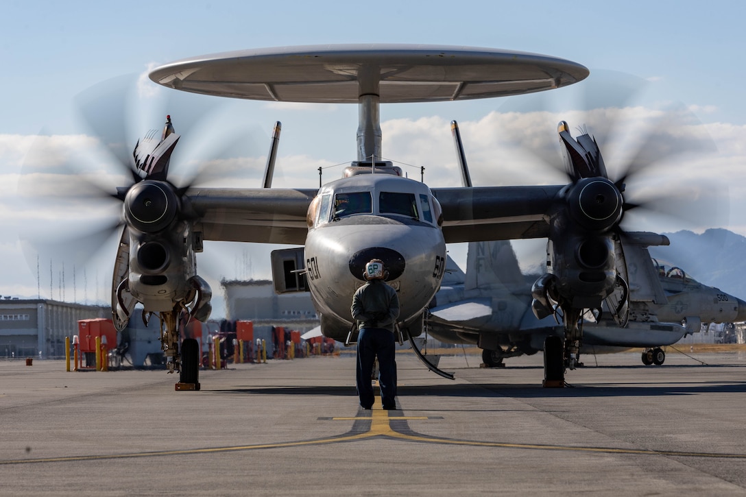 U.S. Navy Cmdr. Daniel Yates, the executive officer of Airborne Command & Control Squadron (VAW) 125, Carrier Air Wing (CVW) 5, prepares to embrace his child during a homecoming ceremony at Marine Corps Air Station Iwakuni, Japan, Nov. 14, 2023. CVW-5’s return marked the completion of their most recent deployment aboard the USS Ronald Reagan (CVN 76), where they projected airpower in support of a free and open Indo-Pacific. (U.S. Marine Corps photo by Cpl. Peter Rawlins)