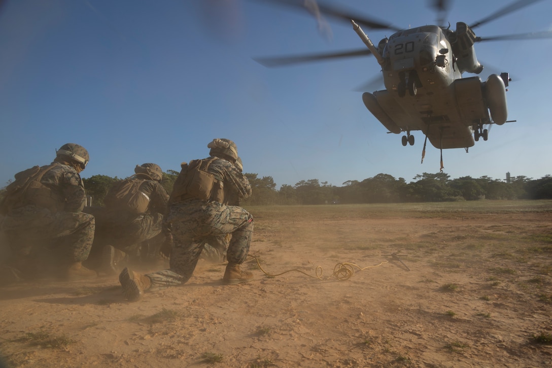 U.S. Marines with Combat Logistics Battalion 31, 31st Marine Expeditionary Unit, brace as a CH-53 Super Stallion approaches for loading during a helicopter support team exercise on Camp Hansen, Okinawa, Japan, Nov. 7, 2023. The HST exercise was conducted to refine key skills for pilots and landing support Marines in sling loading operations. The 31st MEU, the Marine Corps’ only continuously forward-deployed MEU, provides a flexible and lethal force in ready to perform a wide range of military operations as the premiere crisis response force in the Indo-Pacific region. (U.S. Marine Corps photo by Cpl. Juan K. Maldonado)