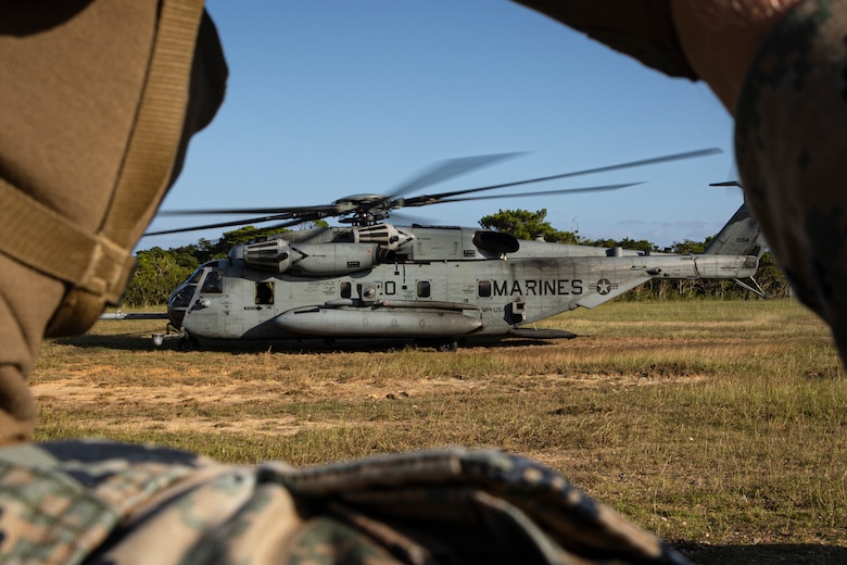 U.S. Marine Corps Cpl. Jacob Wyman with Combat Logistics Battalion 31, 31st Marine Expeditionary Unit, watches a CH-53 Super Stallion Land during a helicopter support team training on Camp Hansen, Okinawa, Japan, Nov. 7, 2023. The HST exercise was conducted to refine key skills for pilots and landing support Marines in sling loading operations. The 31st MEU, the Marine Corps’ only continuously forward-deployed MEU, provides a flexible and lethal force in ready to perform a wide range of military operations as the premiere crisis response force in the Indo-Pacific region. (U.S. Marine Corps photo by Cpl. Juan K. Maldonado)