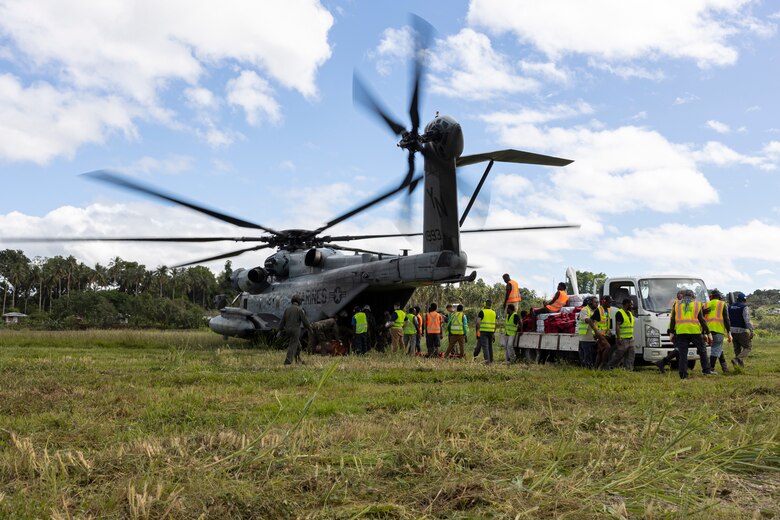 U.S. Marines with the 31st Marine Expeditionary Unit, and Bougainville Disaster Response Joint-Agency workers, load supplies onto a CH-53E Super Stallion during a humanitarian assistance and disaster relief operation on Bougainville Island, Papua New Guinea, Aug. 12, 2023. The amphibious assault ship USS America (LHA 6) and the 31st MEU in coordination with the United States Agency for International Development’s Bureau for Humanitarian Assistance are supporting U.S. government efforts for foreign disaster relief in Bougainville at the request of the government of Papua New Guinea, in consultation with the Autonomous Bougainville Government, after the volcanic eruption of Mount Bagana. (U.S. Marine Corps photo by Lance Cpl. Bridgette Rodriguez)