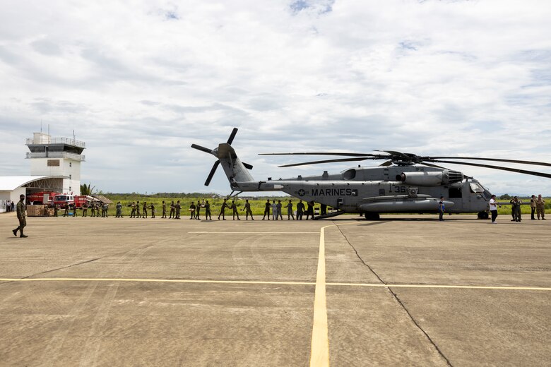 A U.S. Marine Corps CH-53E Super Stallion with Marine Medium Tiltrotor Squadron (VMM) 163 (Reinforced), Marine Aircraft Group 16, 3rd Marine Aircraft Wing, is loaded with emergency relief supplies, provided by the Government of the Philippines, by U.S. Marines and Philippine servicemembers and citizens, while conducting relief efforts in the wake of Typhoon Egay, international name Typhoon Doksuri, at Cagayan North International Airport, Lal-lo, Cagayan province, Philippines, Aug. 3, 2023. At the request of the Armed Forces of the Philippines, U.S. Marines are providing relief and lifesaving capabilities to remote regions of the Philippines. The forward presence and ready posture of I Marine Expeditionary Force assets in the region facilitated rapid and effective response to crisis, demonstrating U.S. commitment to Allies and partners. During the three days of relief efforts, VMM-163 (Rein.) delivered approximately 64,000 pounds of food and water, provided by the Government of the Philippines, to remote, affected communities. (U.S. Marine Corps photo by Sgt. Sean Potter)