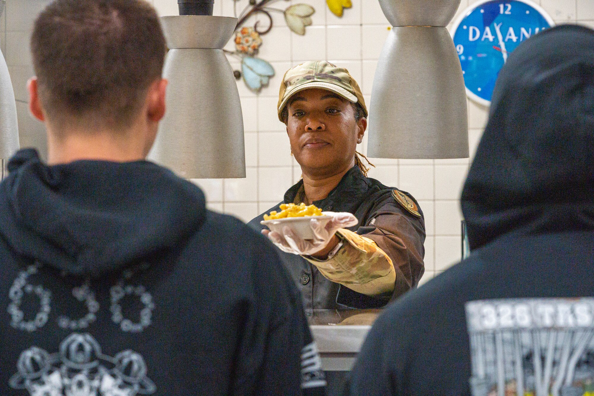 U.S. Air Force Chief Master Sgt. Tiffany Brown, 81st Force Support Squadron senior enlisted leader, serves an Airman during the Thanksgiving meal at Keesler Air Force Base, Mississippi, Nov. 23, 2023.