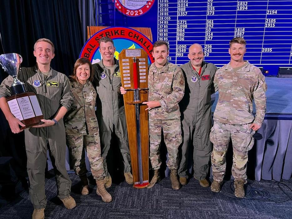 Airmen from Ellsworth Air Force Base pose with the Ellis Giant Sword trophy at Barksdale Air Force Base, Louisiana, Nov. 8, 2023.