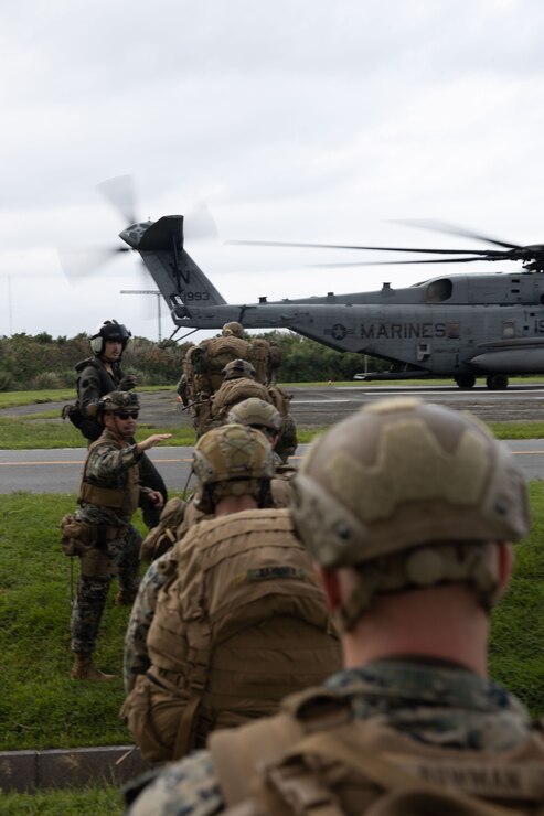 U.S. Marines with Battalion Landing Team 2/1, 31st Marine Expeditionary Unit, prepare to board a CH-53E Super Stallion helicopter during an embassy evacuation as part of a Joint Interagency Intergovernmental and Multinational Exercise (JIIMEX), at Camp Courtney, Okinawa, Japan, Oct. 5, 2023 The exercise utilizes a forward command element, which is deployed to an area of operations to assist the embassy in exploring all the capabilities that the 31st MEU can provide, which includes providing logistics support and additional security and creating and executing an evacuation plan. The 31st MEU, the Marine Corps’ only continuously forward-deployed MEU, provides a flexible and lethal force ready to perform a wide range of military operations as the premier crisis response force in the Indo-Pacific region. (U.S. Marine Corps photo by Cpl. Christopher Lape)