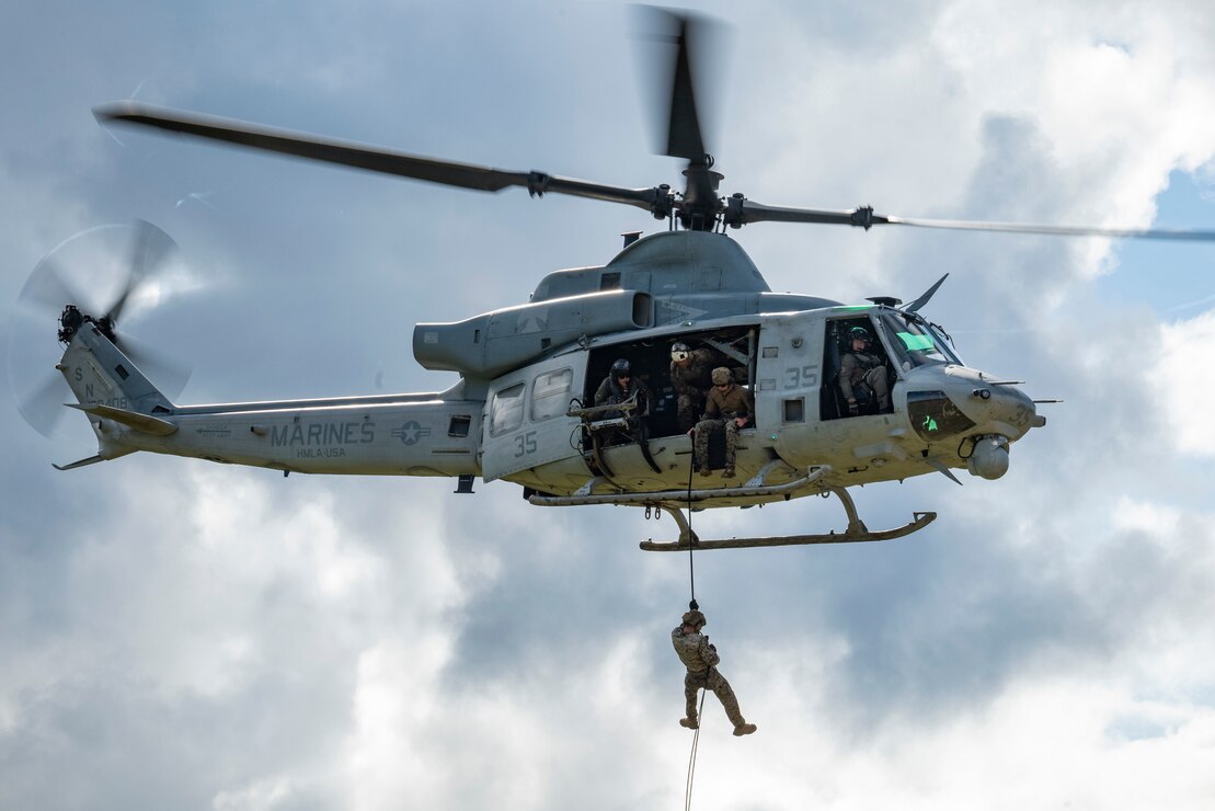 U.S. Marines with III Marine Expeditionary Force rappel from a UH-1Y Venom assigned to Marine Light Attack Helicopter Squadron 169 during special patrol insertion and extraction training at Landing Zone Starling, Camp Schwab, Okinawa, Japan, Sept. 21, 2023. Fast rope and helicopter rope suspension training teach Marines proper knots, rappelling techniques and build confidence for maneuvering from air to ground. (U.S. Marine Corps photo by Cpl. Tyler Andrews)