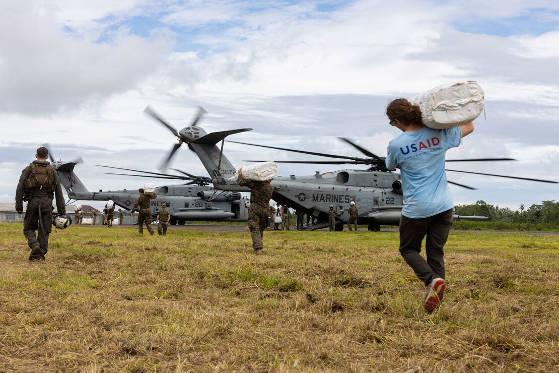 U.S. Marines with the 31st Marine Expeditionary Unit alongside United States Agency for International Development workers, load supplies onto a CH-53E Super Stallion during a humanitarian assistance and disaster relief operation on Bougainville Island, Papua New Guinea, Aug. 13, 2023. The amphibious assault ship USS America (LHA 6) and the 31st MEU are working in coordination with the United States Agency for International Development’s Bureau for Humanitarian Assistance at the request of the government of Papua New Guinea, in consultation with the Autonomous Bougainville Government, after the volcanic eruption of Mount Bagana. (U.S. Marine Corps photo by Lance Cpl. Bridgette Rodriguez)