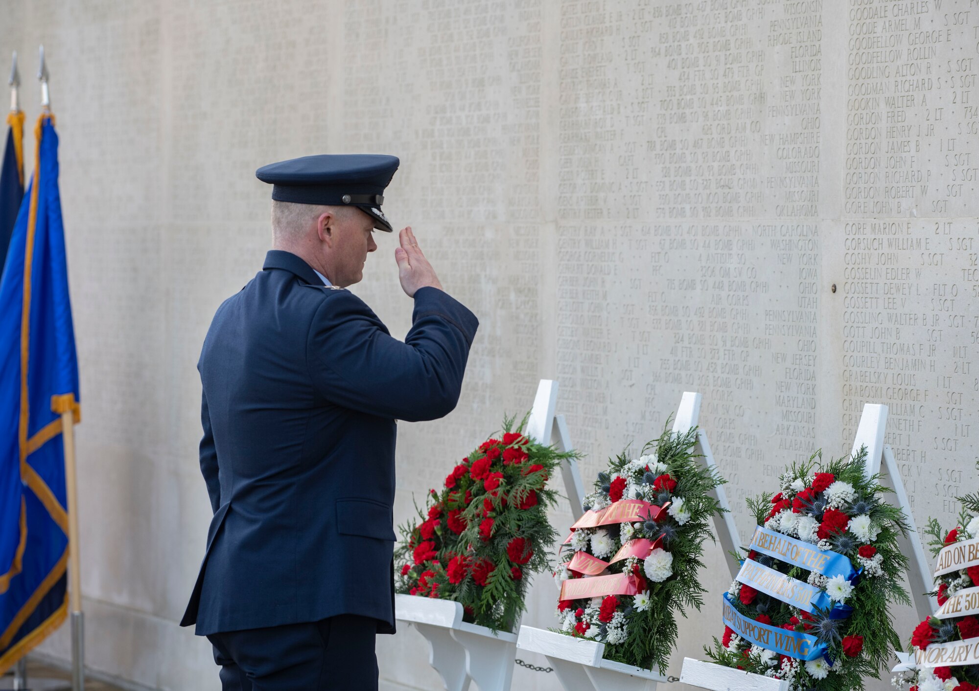 Col. D. Landon Phillips, 501st Combat Support Wing commander, salutes the wreath he laid at the Cambridge American Cemetery and Memorial, England