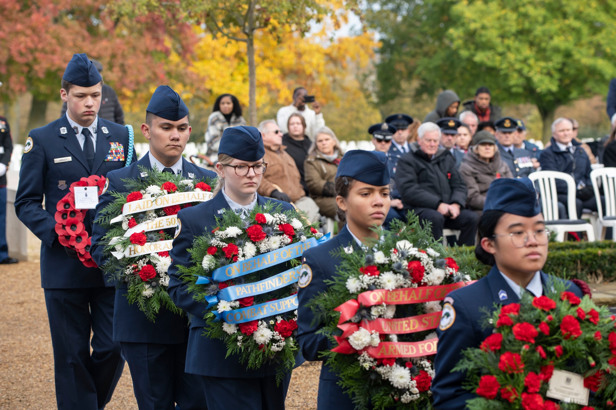 Members of the Alconbury Middle High School Junior Reserve Officer Training Corp carry wreaths at the Cambridge American Cemetery and Memorial, England