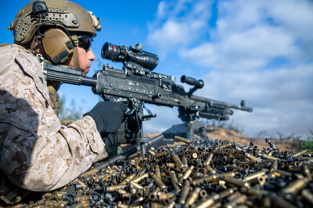 U.S. Marine Corps Lance Cpl. Gary Gonzalez, an infantry rifleman with Fleet Anti-Terrorism Security Team Company, Europe (FASTEUR) and native of Victoria, Texas, fires an M240 machine gun over a hill during a live-fire shoot at a firing range in Lielvārde Airfield, Latvia, Oct. 5, 2023. Task Force 61/2.3 (FASTEUR), under the tactical command and control of Task Force 61/2, provides capabilities such as rapid response expeditionary anti-terrorism and security operations in support of Commanders, United States European Command (COMESEUCOM) and as directed by Commander, U.S. 6th Fleet (C6F) in order to protect vital naval and national assets. (U.S. Marine Corps photo by Lance Cpl. Jack Labrador)