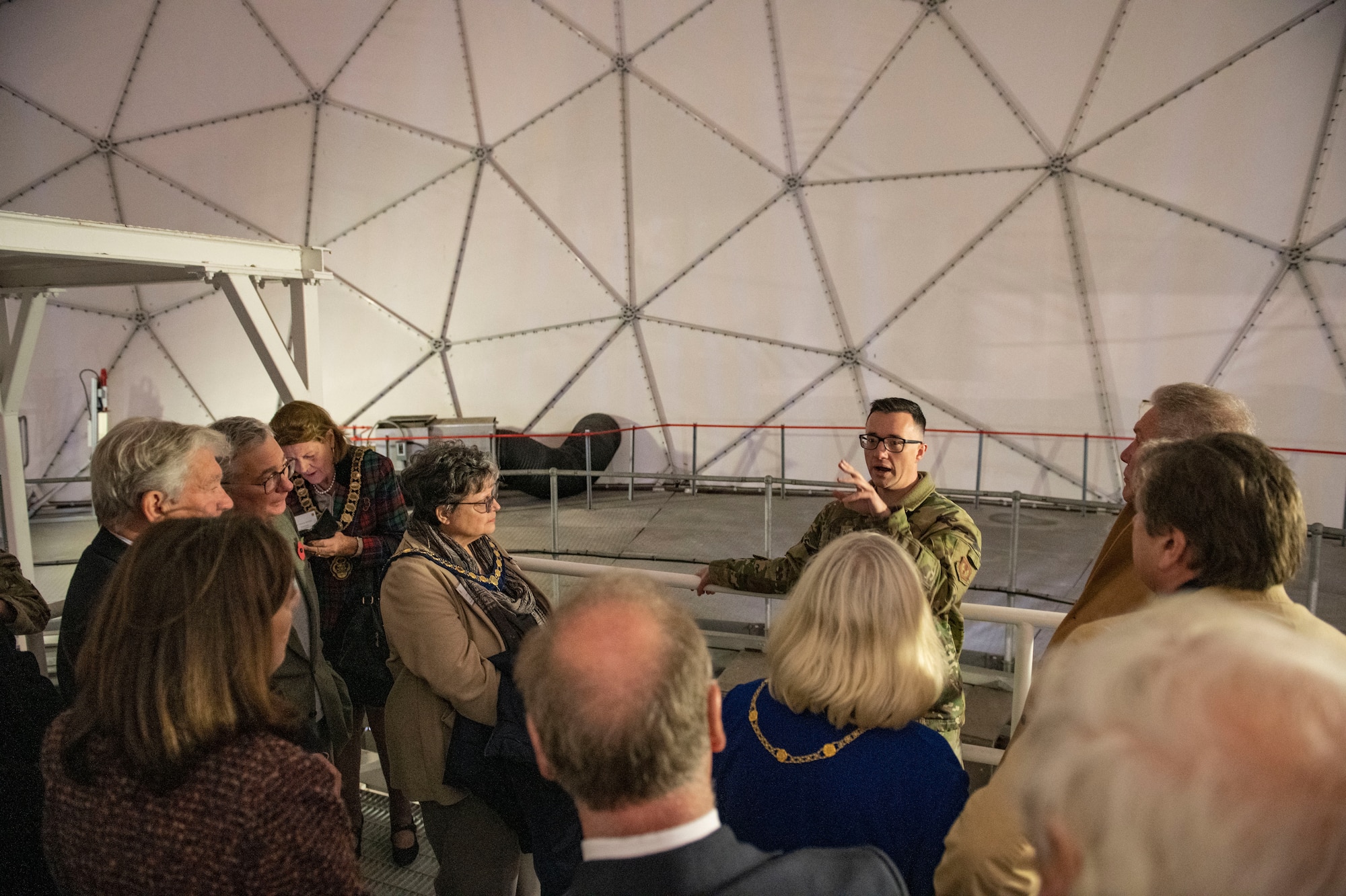 Tech. Sgt. Micah Moore, 422d Communications Squadron satellite communications gateway supervisor, center right, briefs local civic leaders about the satellite communication mission at RAF Croughton