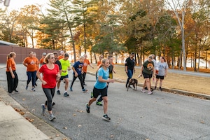 Participants cross the starting line to begin the 38th annual Arnold Engineering Development Complex Turkey Trot, Nov. 7, 2023, at the Arnold Lakeside Complex at Arnold Air Force Base, Tenn. The event included members of the AEDC workforce. (U.S. Air Force photo by Keith Thornburgh)