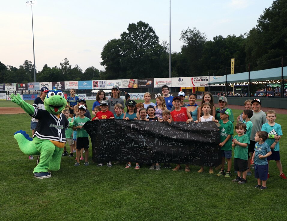 VTNG Military Family children pose with Champ at the 2023 Lake Monsters Military Family Night.