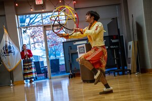 Malcolm McDonald performs a traditional interpretive dance creating a sphere with hoops